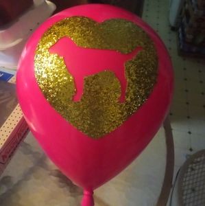 Pink plastic balloon doesn't have a stand has the gold glitter dog logo on iT
